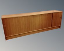 A 20th century Danish teak sliding door low sideboard.