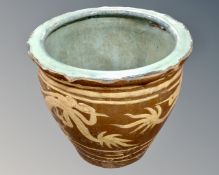 An Oriental glazed planter. height 48 cm, diameter top 41 cm, bottom 34 cm.