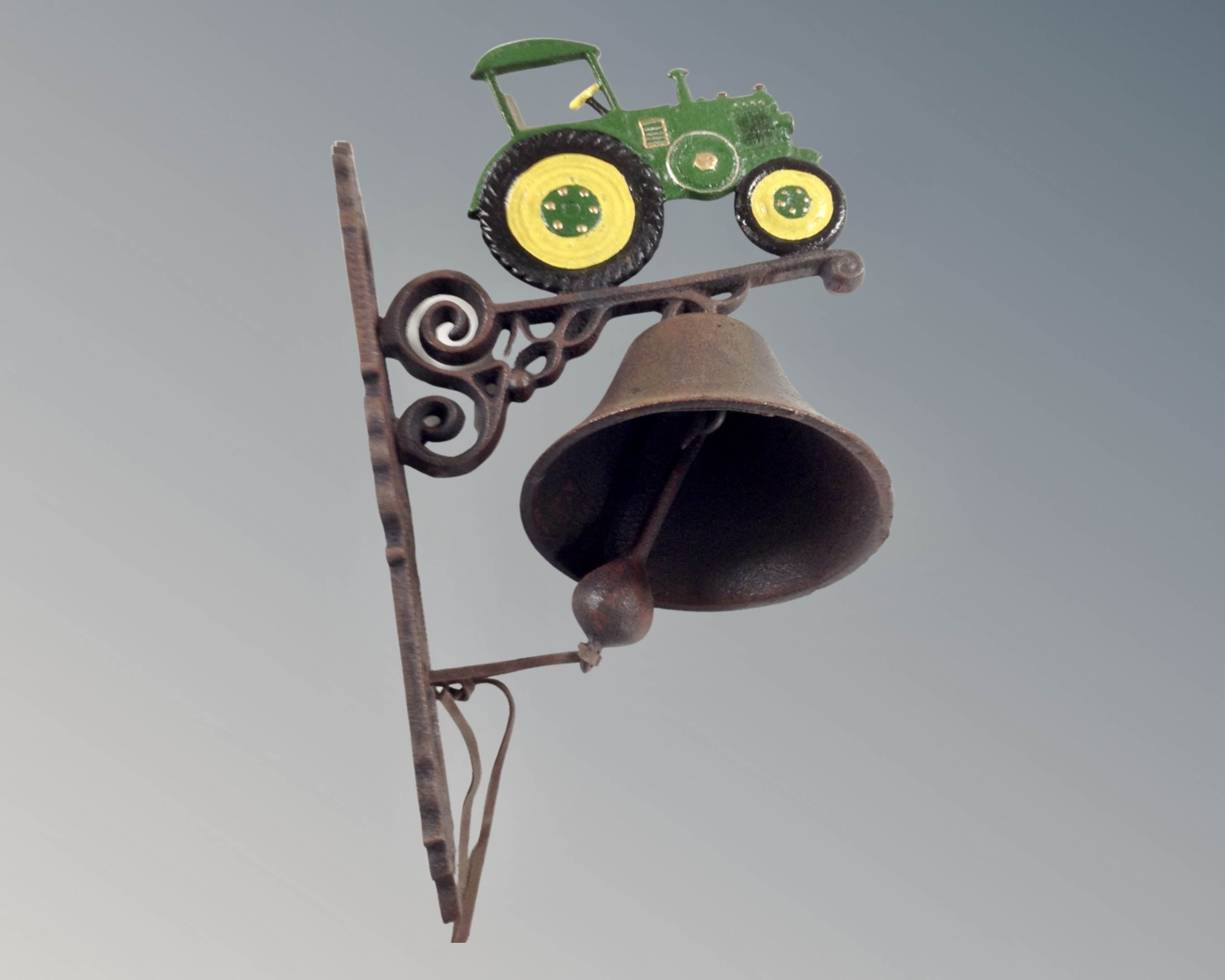A cast iron tractor wall bracket with bell.