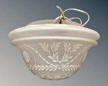 An early 20th century opaque glass light shade with hand painted decoration.