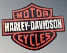 A cast iron Harley-Davidson wall plaque.
