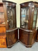 Two corner display cabinets fitted with cupboards beneath in a mahogany finish.