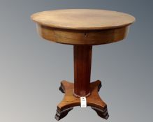 A continental mahogany oval pedestal work table.