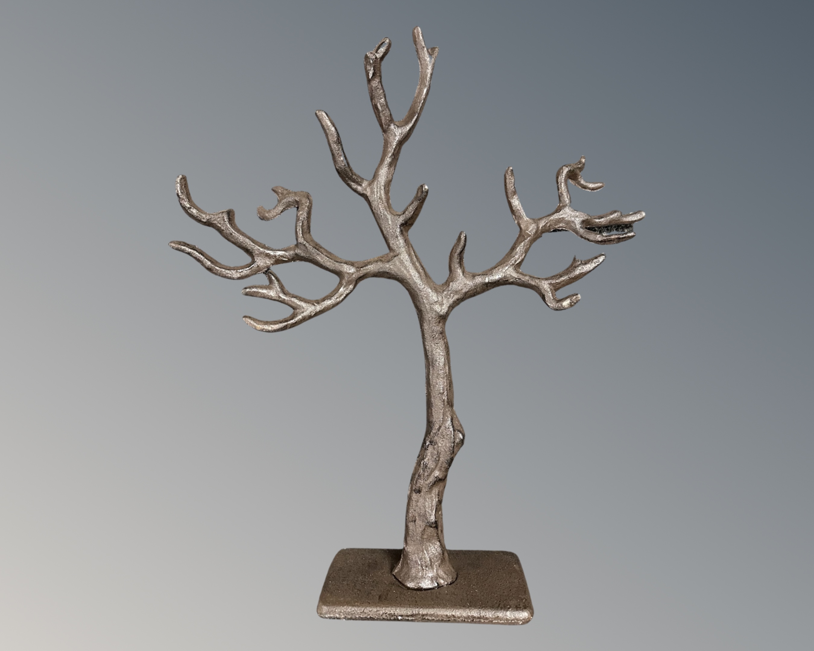 A cast iron jewellery stand in the form of a tree.