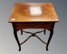 A 20th century mahogany work table on raised legs.