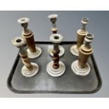 A tray containing six wooden and plated metal candlesticks.