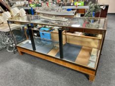 An early 20th century brass framed shop display cabinet with sliding doors.