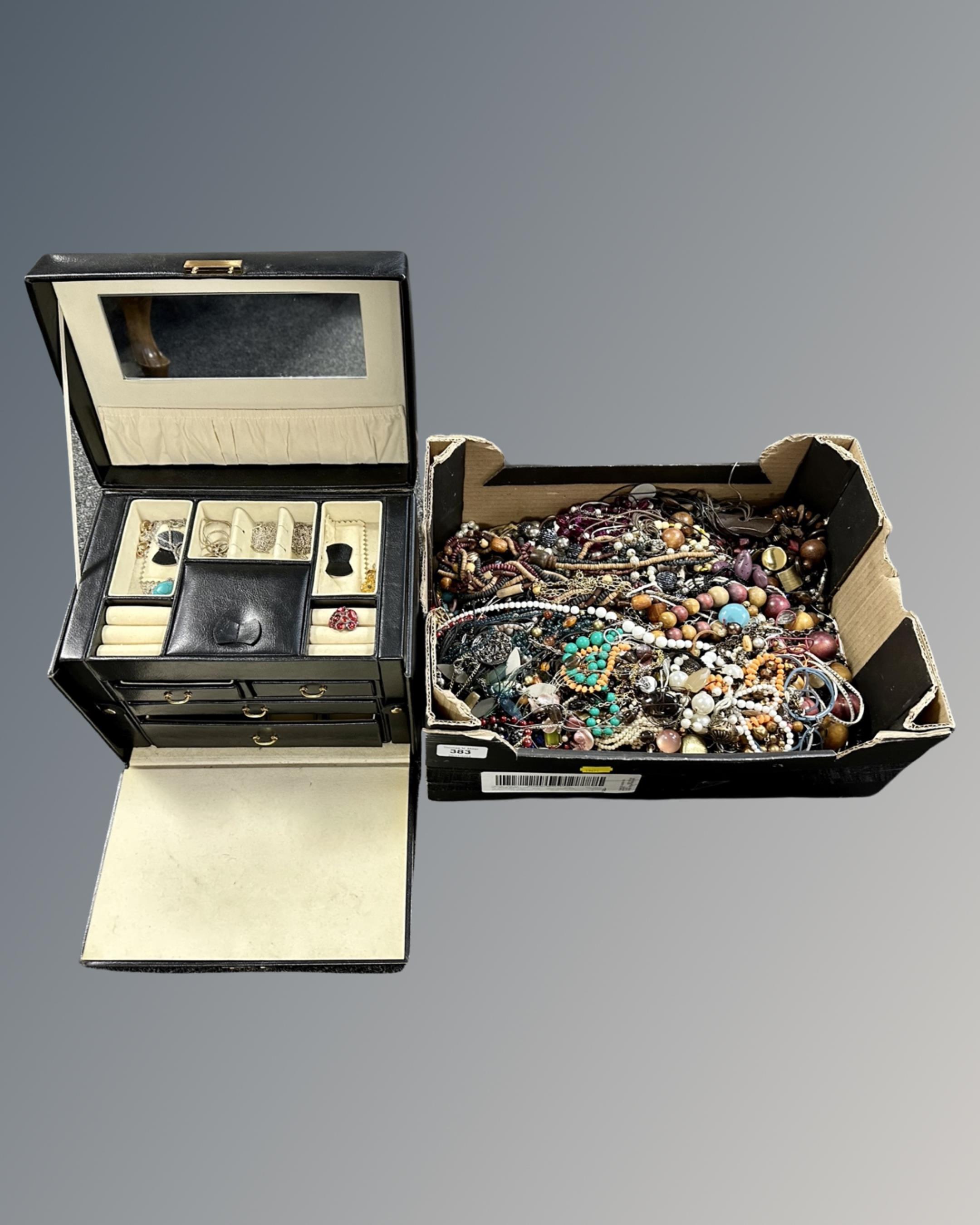 A leather travel jewellery case and a box containing a large quantity of silver and costume