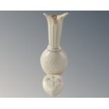 A Belleek vase together with a heart shaped lidded trinket pot.