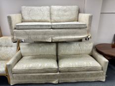 A 20th century Scandinavian two seater settee upholstered in a cream fabric,