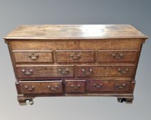 A George III oak mule chest, fitted with three drawers beneath five dummy drawers.