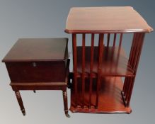 A reproduction inlaid mahogany revolving book stand together with a mahogany sewing box on raised