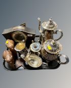 A tray containing a mid-20th century mantel clock, a four-piece plated tea service,