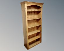 A set of pine open bookshelves.