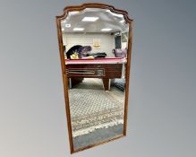 An early 20th century stained beech framed bevelled mirror, 71cm by 151cm.
