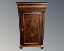 A 19th century walnut single door cabinet fitted with a drawer.