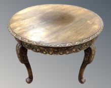 A 20th century circular carved oak occasional table.
