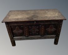 An early 19th century heavily carved oak blanket chest.