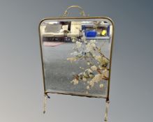 A 19th century brass framed mirrored fire screen with hand painted decoration