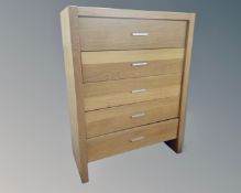 An Ikea five drawer chest in an oak finish