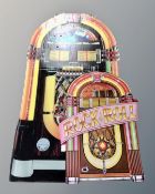 A folding cardboard Wurlitzer advertising sign and folding rock n roll stand
