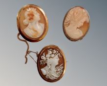 Two cameo brooches mounted in 9ct gold together with a further cameo brooch in white metal.