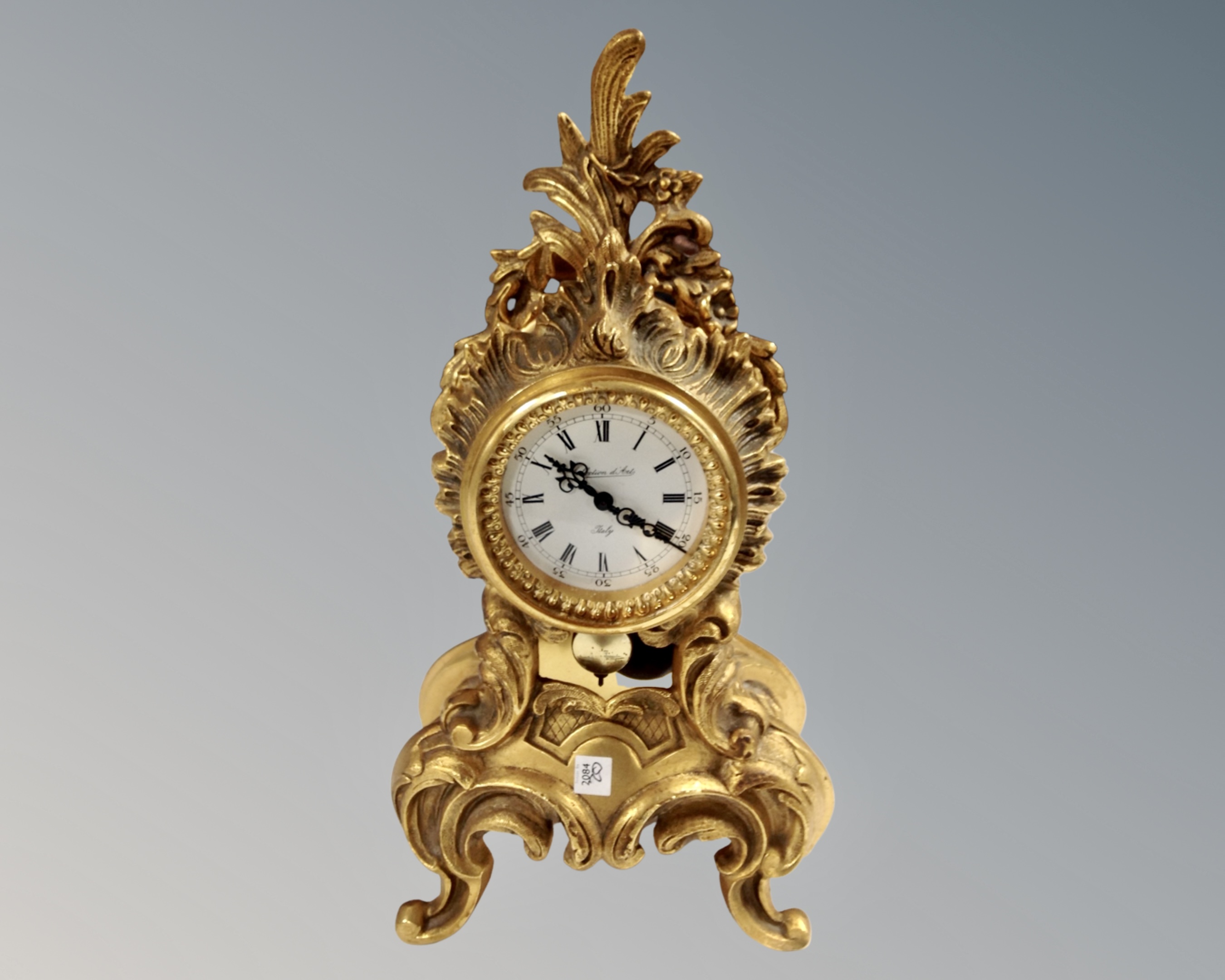 An ornate Italian gilded metal mantel clock