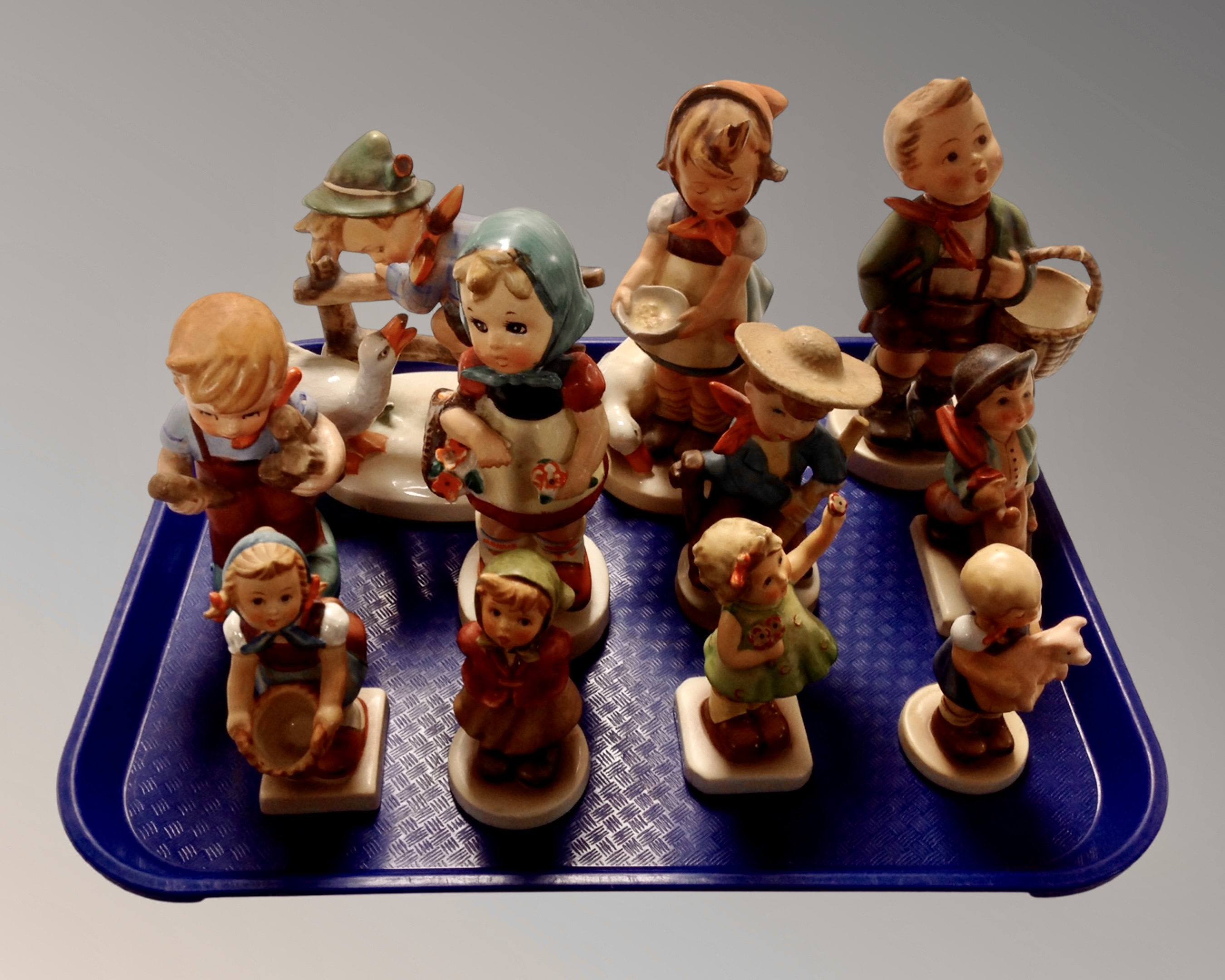 A tray of eleven West German figures including Goebel and Hummel