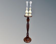 A beech wood barley twist torchere and a pair of alabaster table lamps