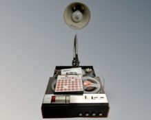 A Philips 4 track reel to reel tape recorder and a grey metal angle poise lamp