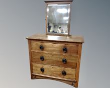 An Edwardian oak Arts & Crafts three drawer chest and a mirror