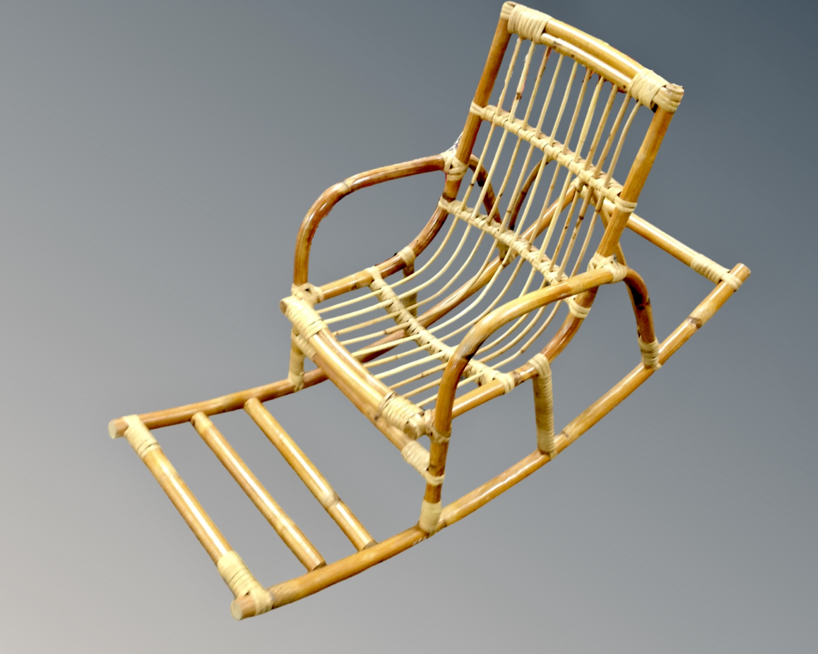 A 20th century bamboo and wicker child's rocking chair