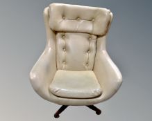 A mid century 'egg' armchair upholstered in cream leather