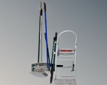 A lawn aerator together with a metal sack barrow / folding step and garden tools