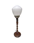 An oak barley twist table lamp with opaque glass shade.
