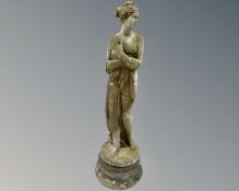 A concrete garden statue of Pandora on plinth,