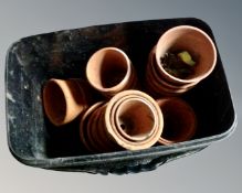 A tub of small terracotta plant pots