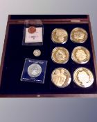 A coin collector's case containing six commemorative struck gilt coins,