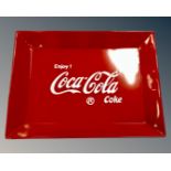 A reproduction Coca Cola tin tray