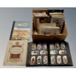 A box of cigarette and tea cards in albums