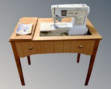 A Singer 438 electric sewing machine in teak table