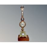 A gilt metal and alabaster eight day wall clock surmounted by a figure,