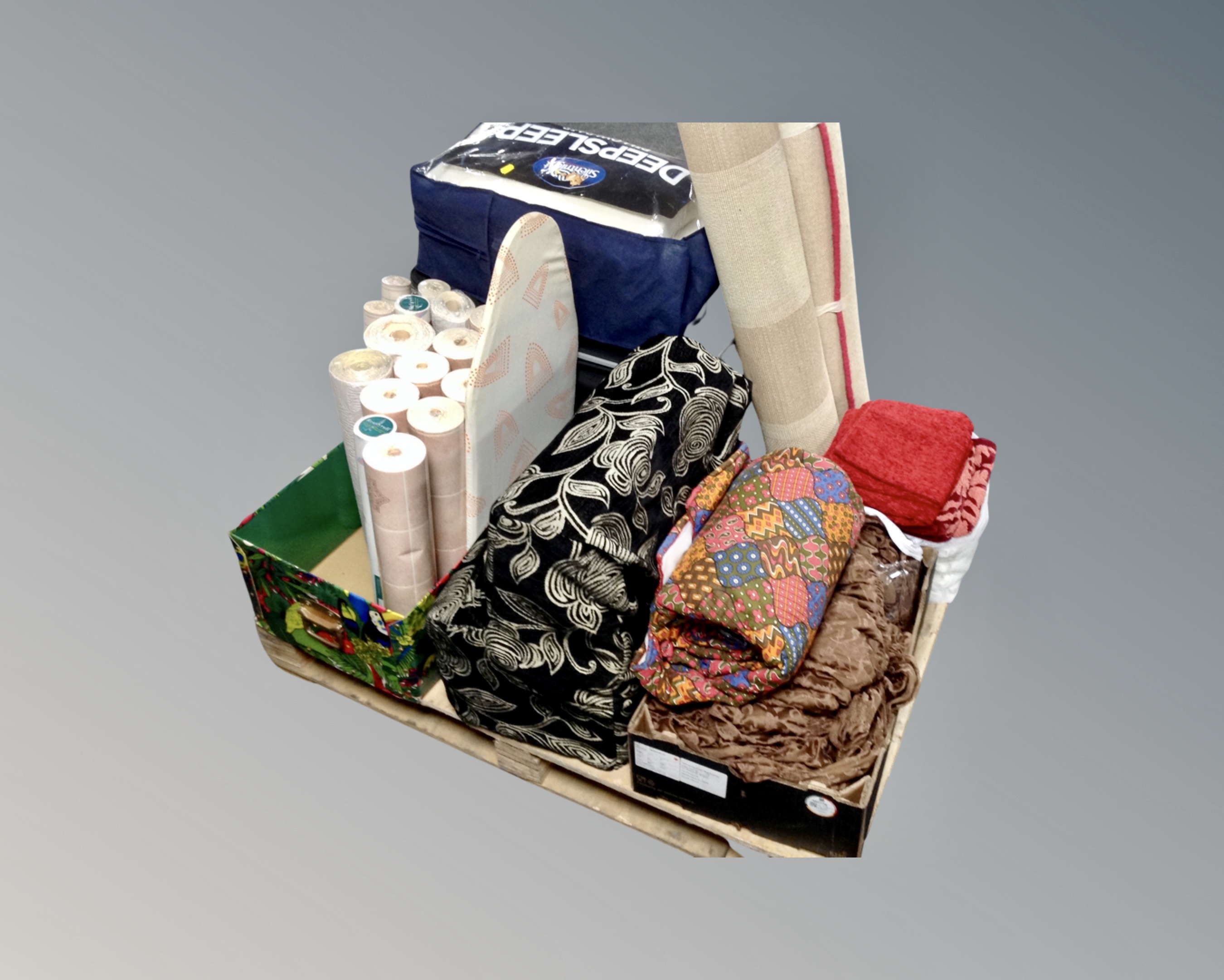 A pallet of wallpaper, luggage cases, rug, cushion covers, memory foam pillows,
