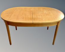 A 20th century teak oval extending dining table