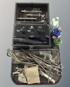 A tray of vintage medical instruments, glass chemist's bottles,