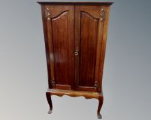 An Edwardian mahogany double door music cabinet