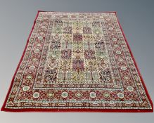 A machine made Persian design carpet on red ground,