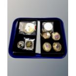 Two coin boxes containing a collection of seven commemorative struck coins, some with certificates,