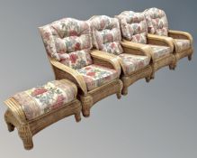 A set of four bamboo wicker conservatory armchairs in floral fabric