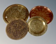 Three Eastern copper and brass serving trays together with a leaf plaque